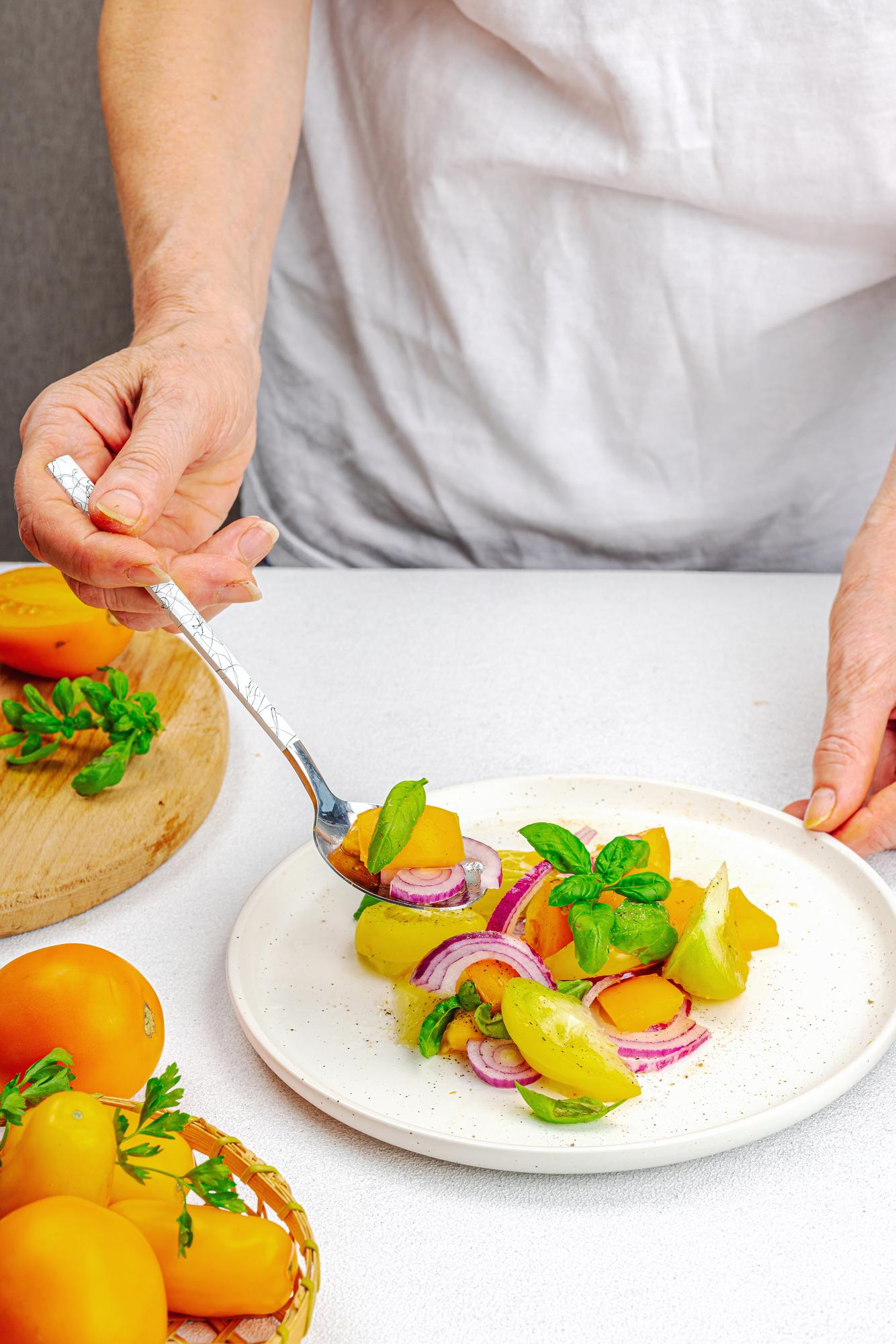 Chef plating a quick colorful meal on a wooden table